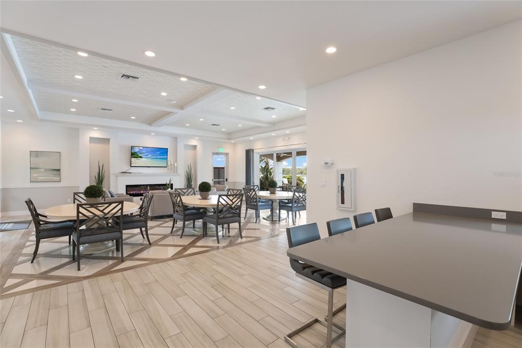 10520 Boardwalk Loop, Unit 301 Bradenton, FL 34202 - Photo 45 of 55 a living room with lots of furniture a wooden floor and white walls