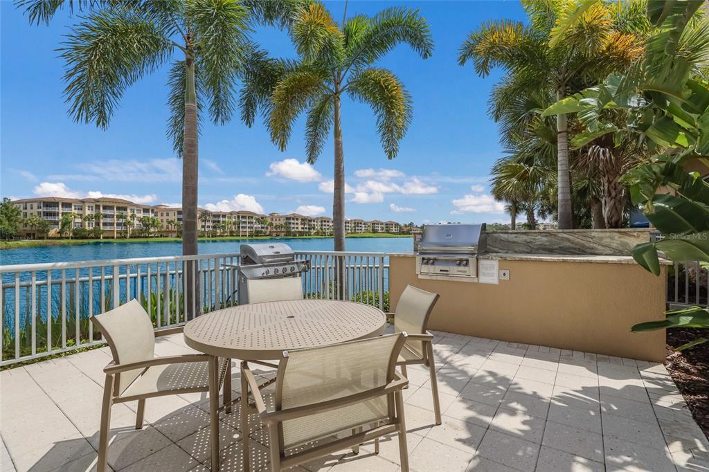 10520 Boardwalk Loop, Unit 301 Bradenton, FL 34202 - Photo 50 of 55 a view of a chairs and table on the terrace