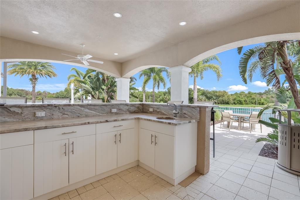 10520 Boardwalk Loop, Unit 301 Bradenton, FL 34202 - Photo 51 of 55 a kitchen with stainless steel appliances granite countertop a sink and cabinets
