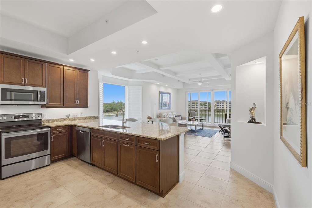 10520 Boardwalk Loop, Unit 301 Bradenton, FL 34202 - Photo 8 of 55 a kitchen with sink cabinets and stainless steel appliances