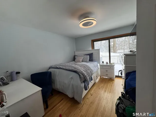 a bedroom with a bed and a large window