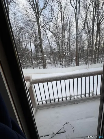 a bedroom with a bed and a flat tv screen on dresser