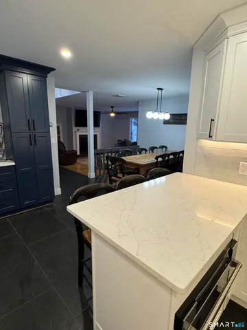 a large kitchen with kitchen island a sink stainless steel appliances and cabinets