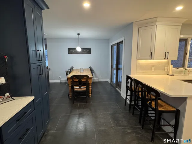 a view of kitchen with sink and breakfast area