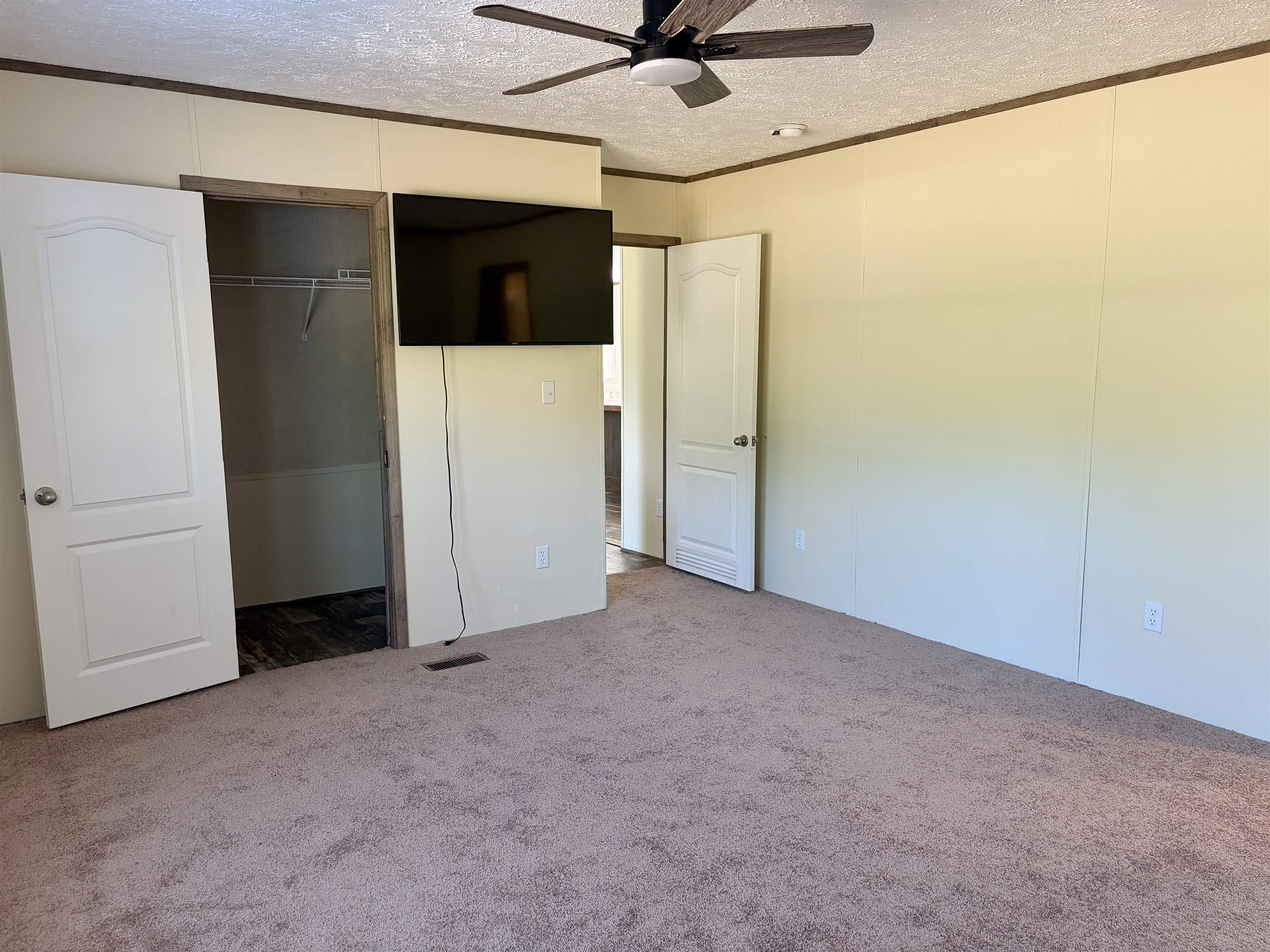 2030 Nubbin Ridge Road Middleton, TN 38052 - Photo 14 of 28 Spacious interior room featuring light-colored panel walls and a neutral carpeted floor