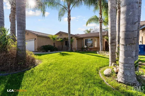 a front view of house with yard and outdoor seating