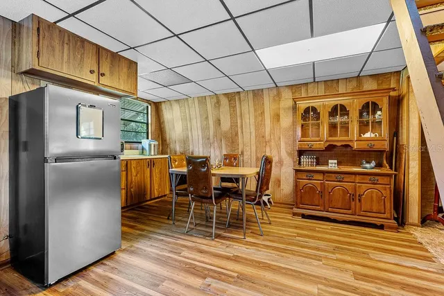 a dining room with stainless steel appliances granite countertop a refrigerator a stove a washer and dishwasher with wooden floor