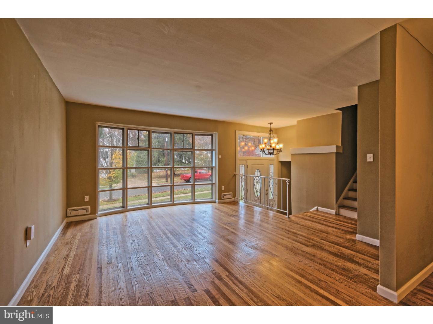 245 Winding Way Road Stratford, NJ 08084 - Photo 5 of 21 a view of an empty room with wooden floor and a window