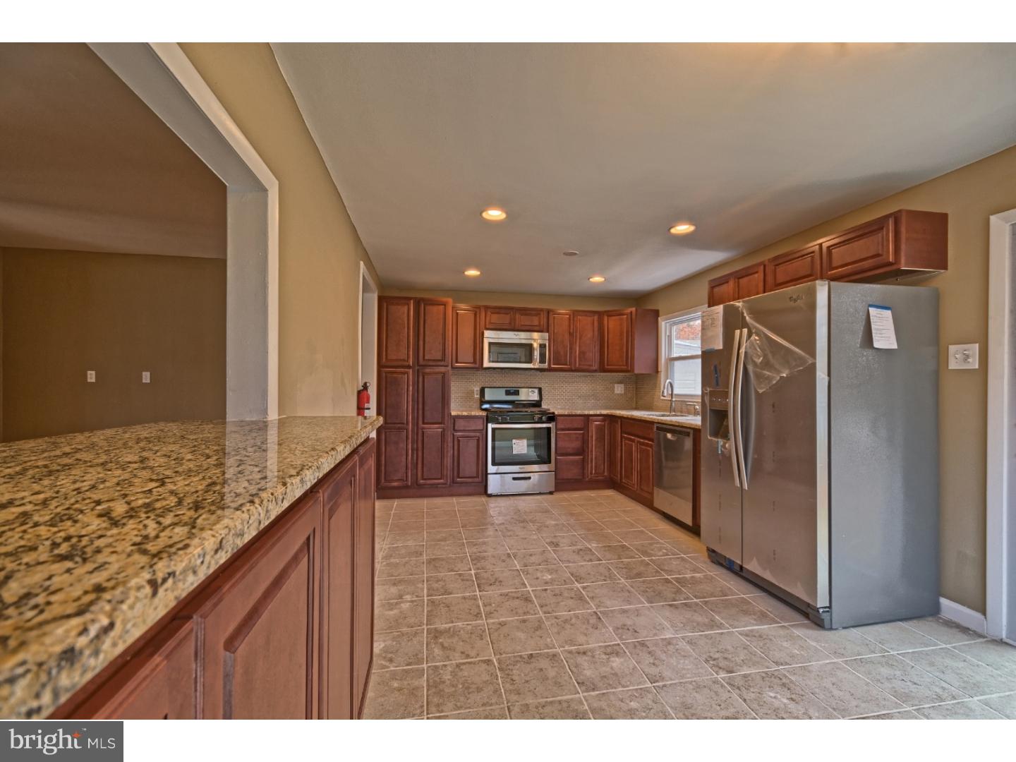 245 Winding Way Road Stratford, NJ 08084 - Photo 8 of 21 a kitchen with stainless steel appliances granite countertop a refrigerator and a sink
