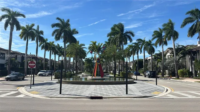 a palm tree sitting on the side of a street