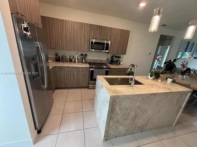 a kitchen with a sink a microwave a refrigerator and washer