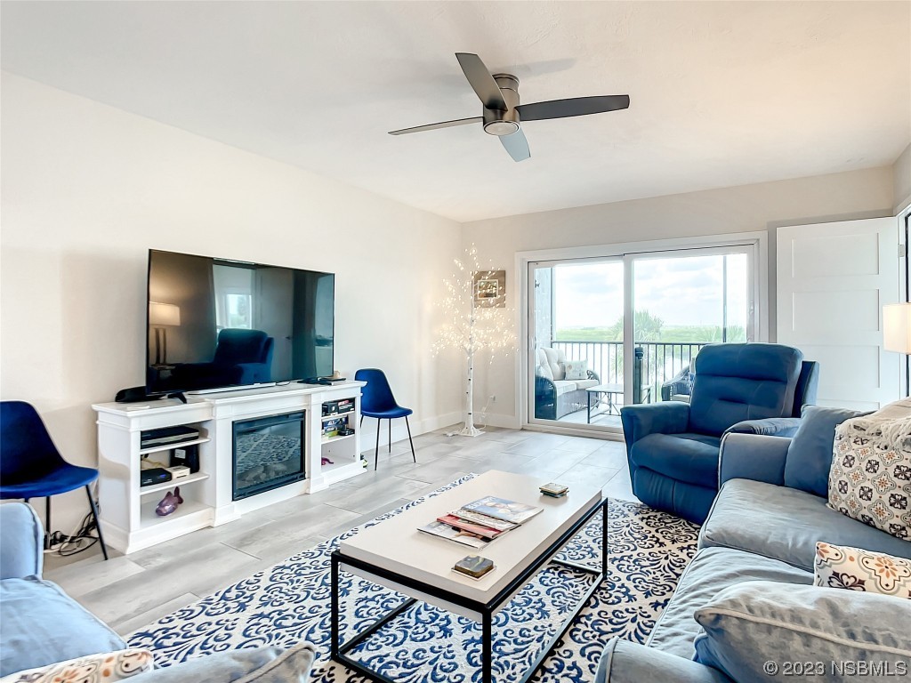 6584 Engram Road, Unit D302 New Smyrna Beach, FL 32169 - Photo 13 of 39 a living room with furniture and a flat screen tv