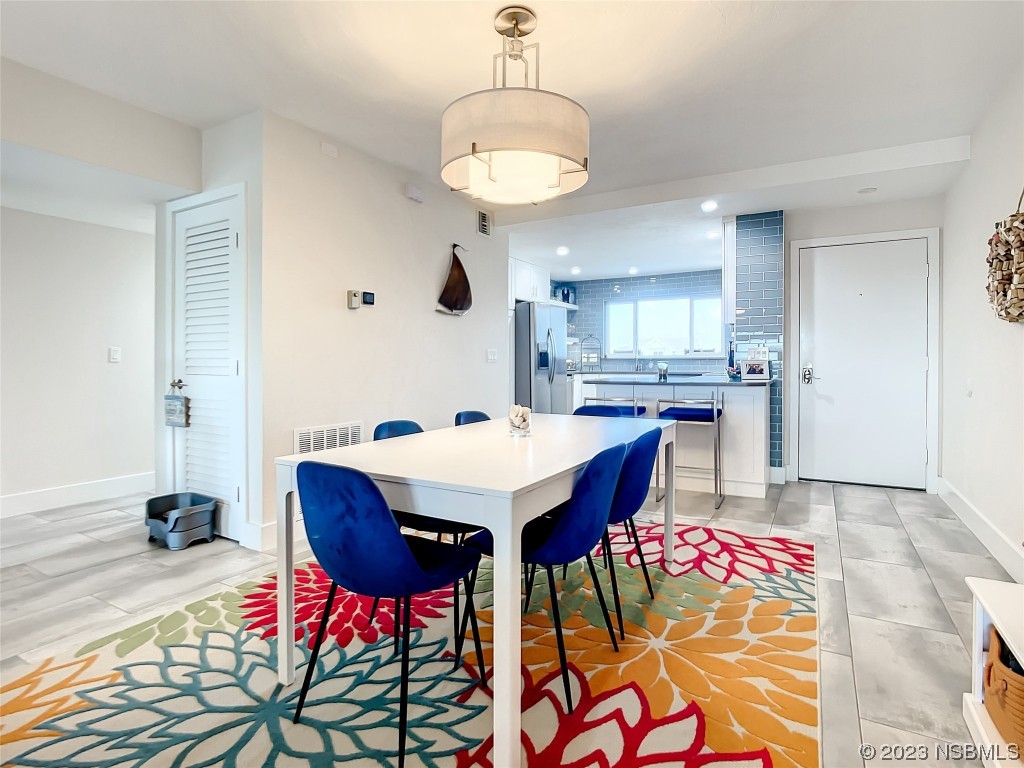 6584 Engram Road, Unit D302 New Smyrna Beach, FL 32169 - Photo 17 of 39 a view of a dining room with furniture