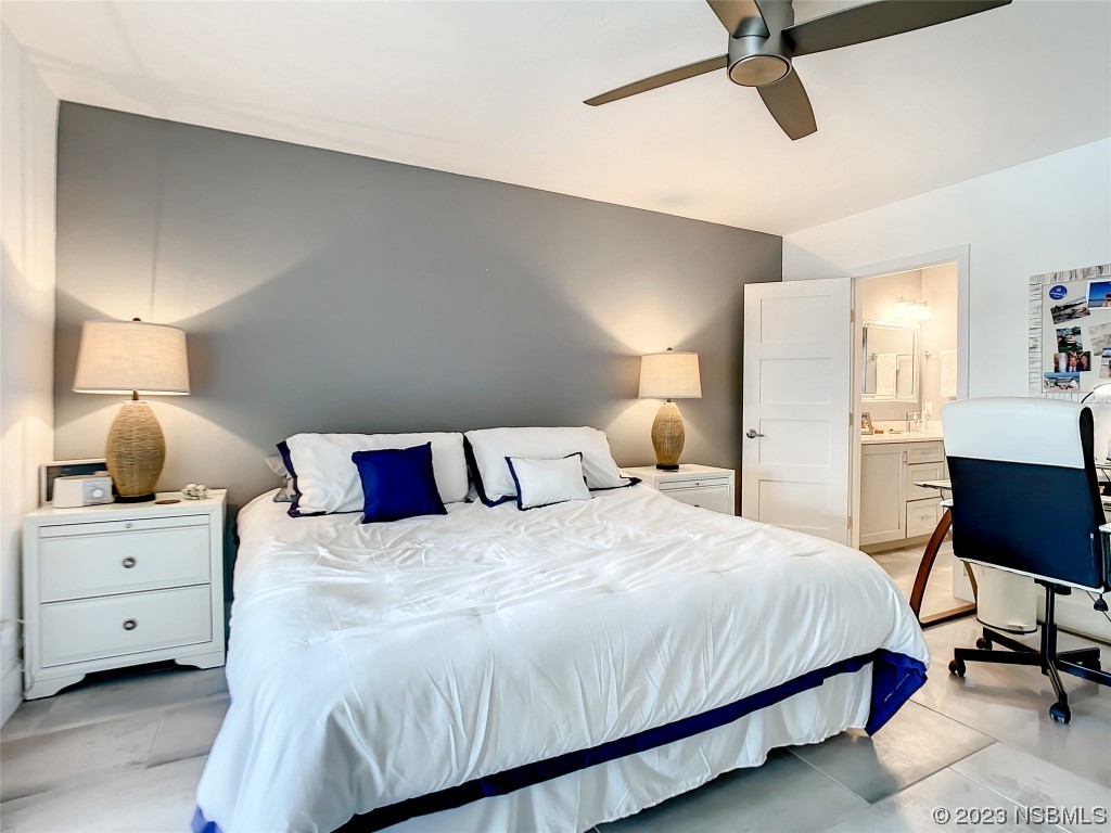 6584 Engram Road, Unit D302 New Smyrna Beach, FL 32169 - Photo 25 of 39 a bedroom with a bed and a chair