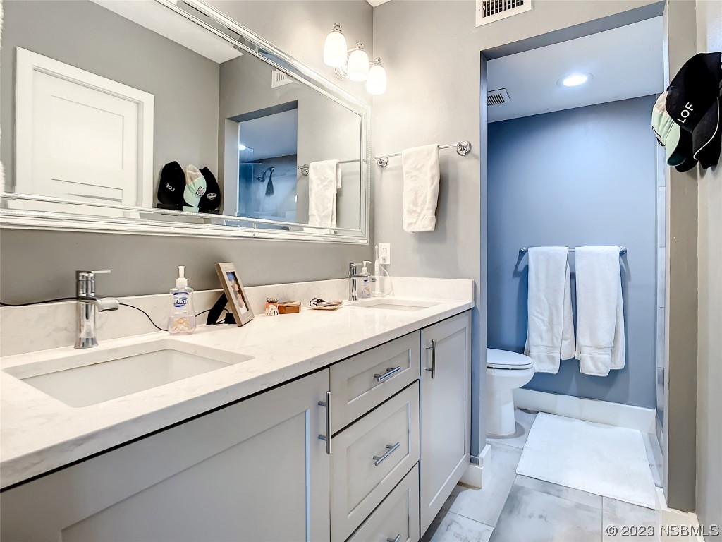 6584 Engram Road, Unit D302 New Smyrna Beach, FL 32169 - Photo 26 of 39 a bathroom with a sink and a mirror