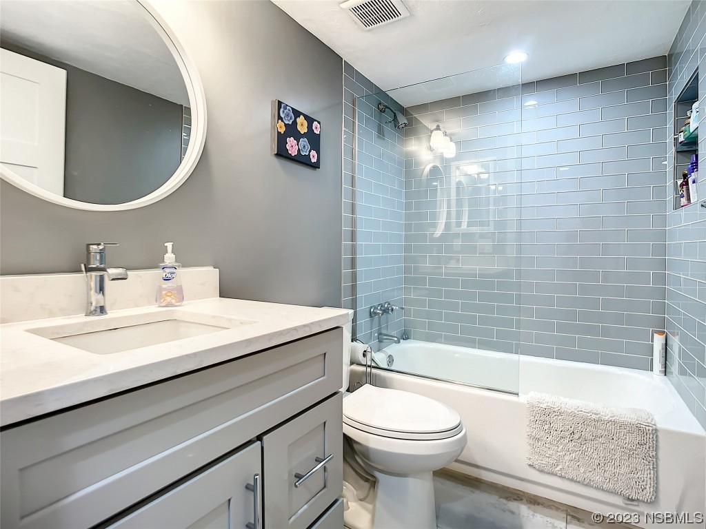 6584 Engram Road, Unit D302 New Smyrna Beach, FL 32169 - Photo 29 of 39 a bathroom with a sink a toilet and shower