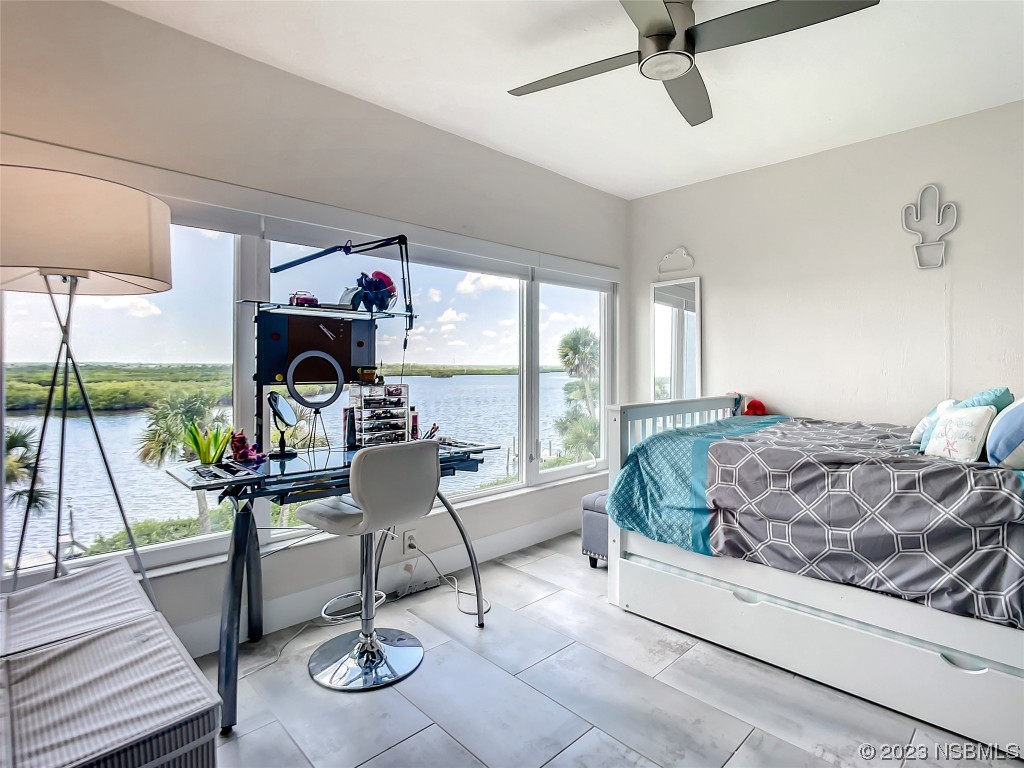 6584 Engram Road, Unit D302 New Smyrna Beach, FL 32169 - Photo 30 of 39 a living room with furniture and a floor to ceiling window