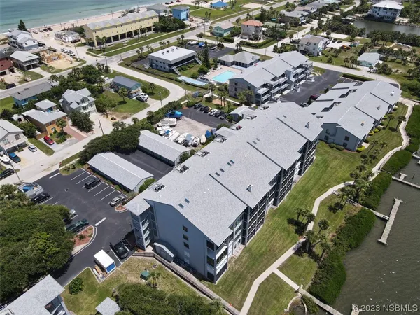 an aerial view of a house with a yard