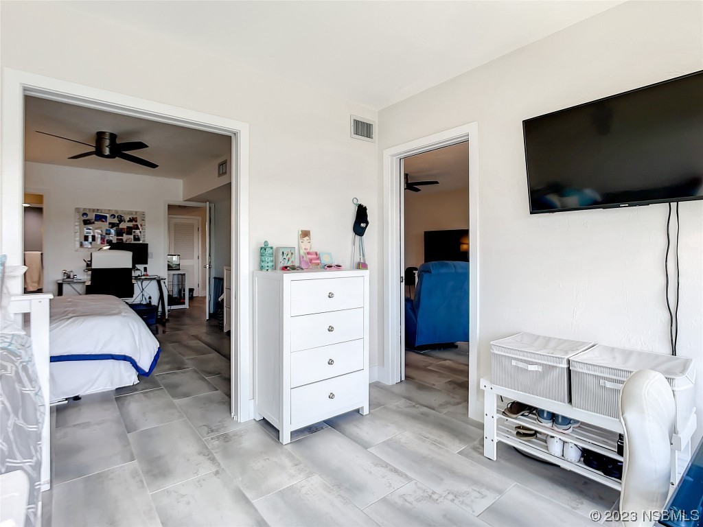 6584 Engram Road, Unit D302 New Smyrna Beach, FL 32169 - Photo 32 of 39 a living room with furniture and a flat screen tv