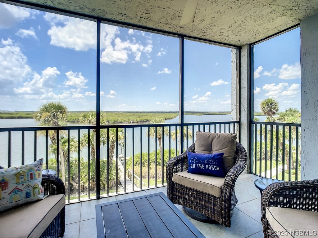 6584 Engram Road, Unit D302 New Smyrna Beach, FL 32169 - Photo 34 of 39 a balcony with furniture and wooden floor