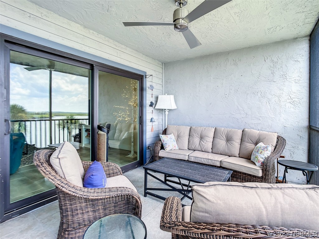 6584 Engram Road, Unit D302 New Smyrna Beach, FL 32169 - Photo 37 of 39 a living room with furniture or couch and a large window