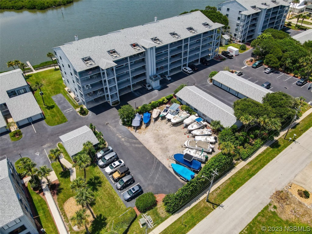 6584 Engram Road, Unit D302 New Smyrna Beach, FL 32169 - Photo 5 of 39 an aerial view of a city