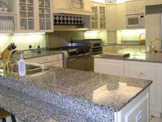 4 Middle Road Sewall's Point, FL 34996 - Photo 2 of 2 a kitchen with stainless steel appliances granite countertop a sink stove and cabinets