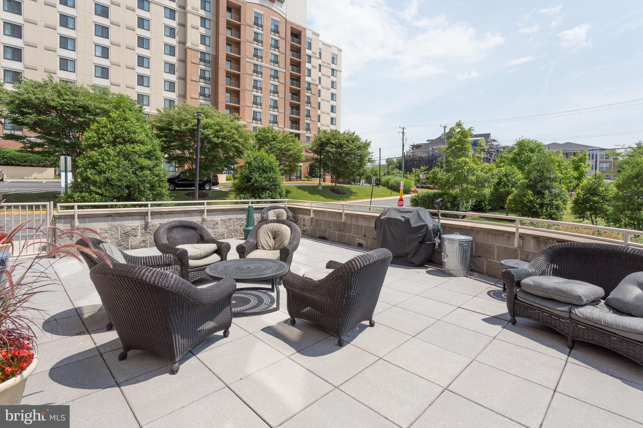 2726 Gallows Road, Unit 712 Vienna, VA 22180 - Photo 40 of 55 a view of a roof deck with couches and potted plants