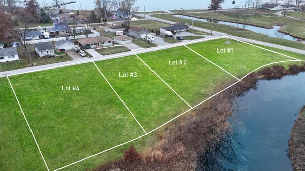 a view of a tennis ground with large trees