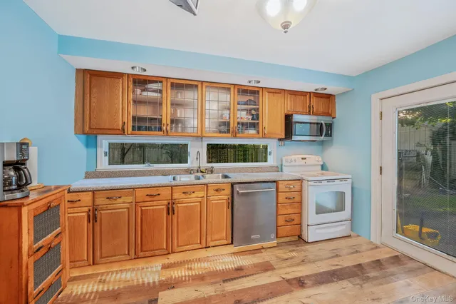 a kitchen with stainless steel appliances a stove sink and cabinets