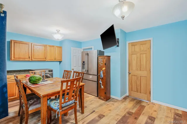 a dining room with furniture and a flat screen tv
