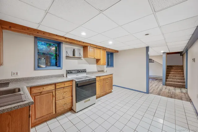 a kitchen with granite countertop a sink and cabinets