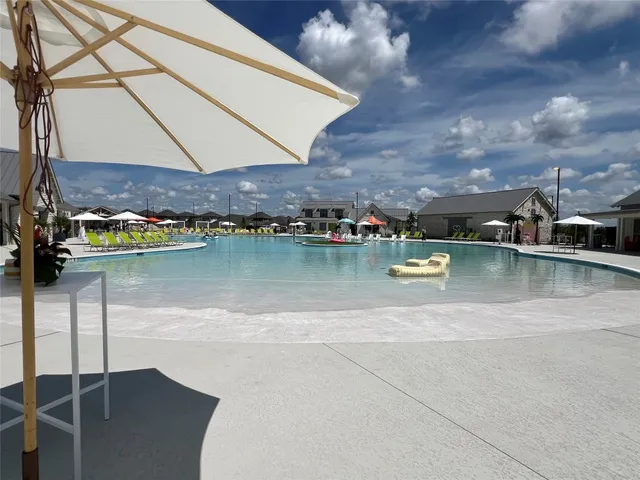 a view of a green field with sitting area