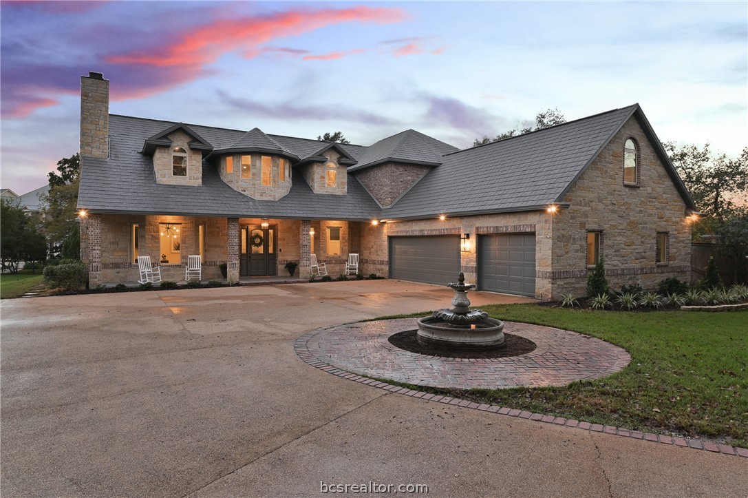 3054 Hickory Ridge Circle Bryan, TX 77807 - Photo 1 of 1 a front view of a house with a fountain and a fountain
