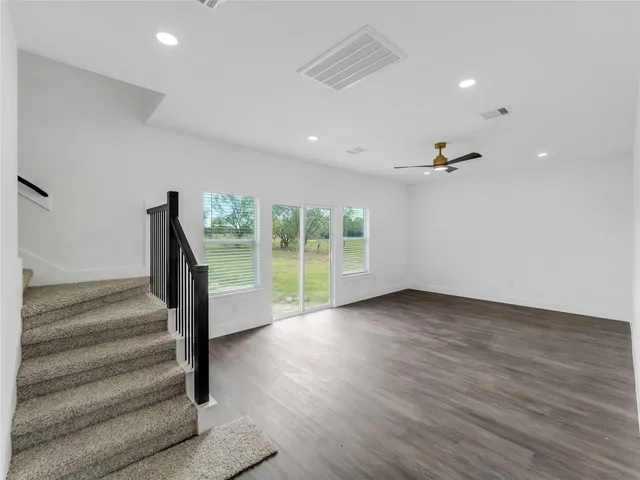 a view of an entryway with wooden floor