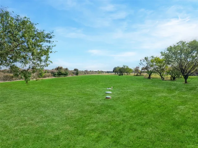 a backyard of a house with lots of green space