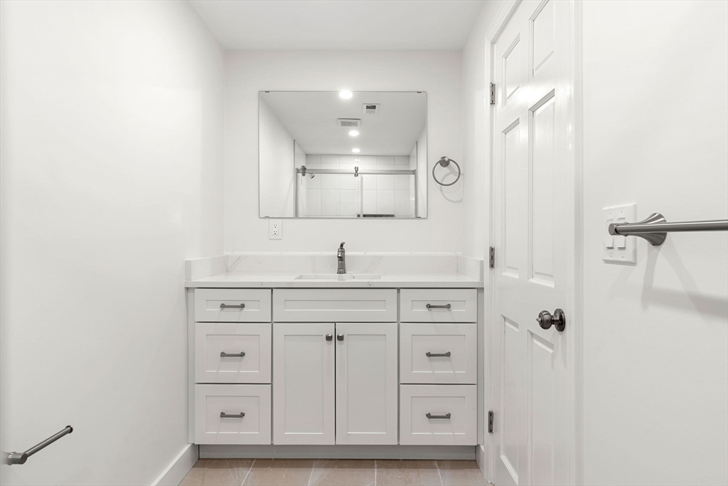 34 Central Street, Unit 2 Rowley, MA 01969 - Photo 11 of 29 a bathroom with a sink vanity and mirror