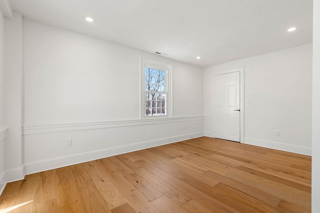 34 Central Street, Unit 2 Rowley, MA 01969 - Photo 19 of 29 an empty room with wooden floor and windows