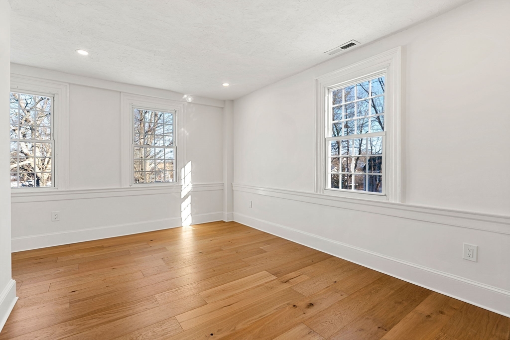 34 Central Street, Unit 2 Rowley, MA 01969 - Photo 20 of 29 a view of an empty room with wooden floor and a window