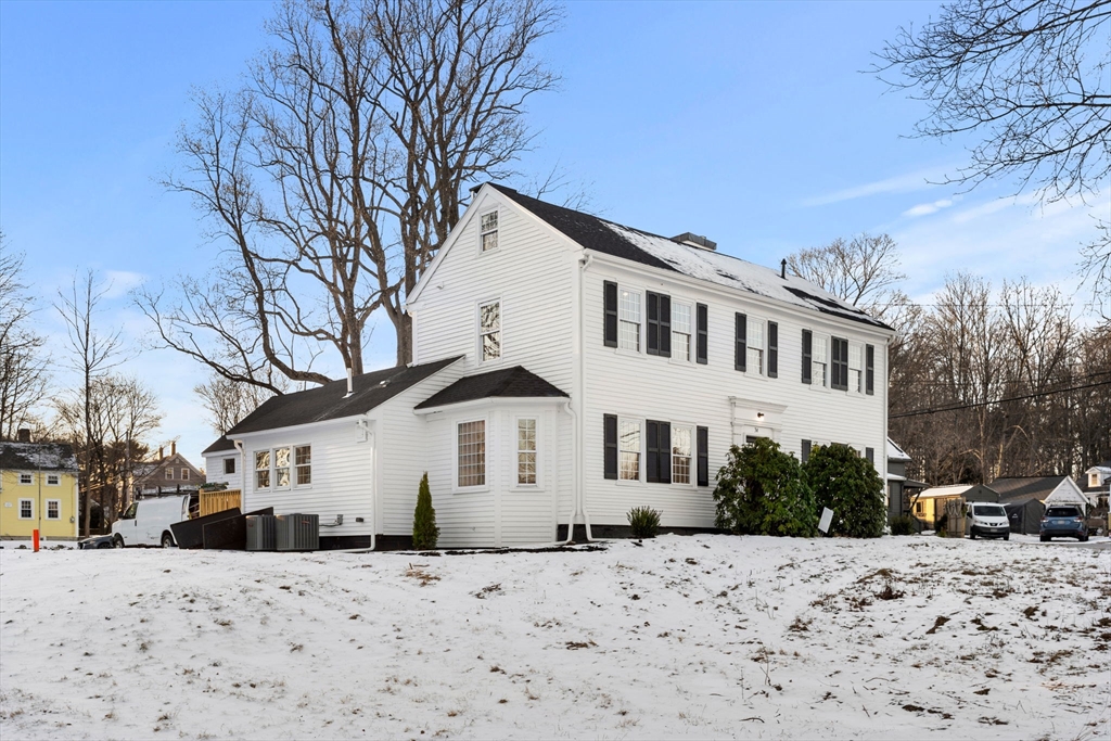 34 Central Street, Unit 2 Rowley, MA 01969 - Photo 2 of 29 a front view of a house with a yard covered in snow