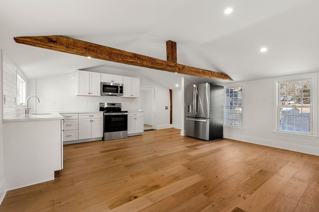 34 Central Street, Unit 2 Rowley, MA 01969 - Photo 8 of 29 a view of kitchen with stainless steel appliances wooden floor and an empty room