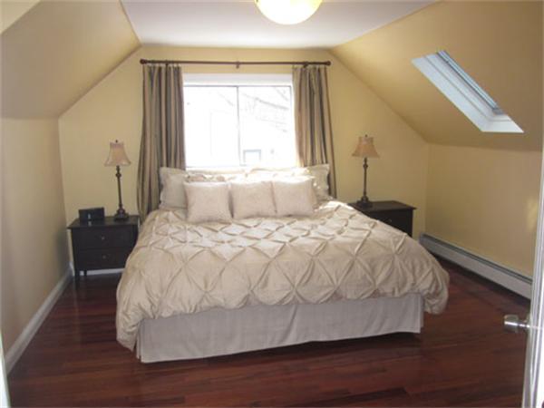 32 Davidson Road Framingham, MA 01701 - Photo 11 of 30 a large bed sitting in a bedroom next to a window