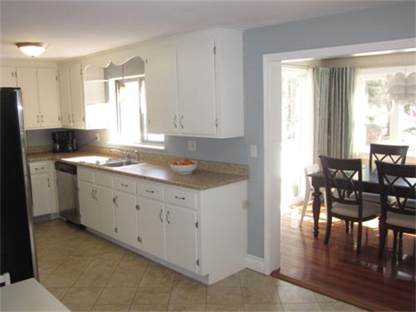 32 Davidson Road Framingham, MA 01701 - Photo 6 of 30 a kitchen with granite countertop a stove a sink a dining table and chairs