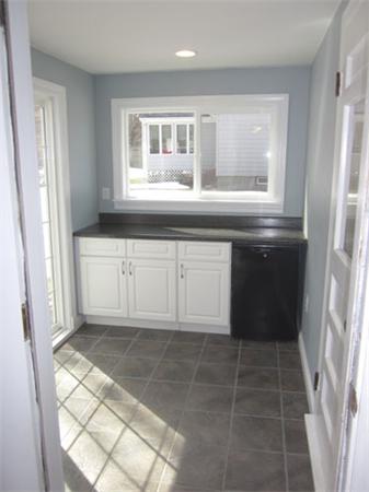 32 Davidson Road Framingham, MA 01701 - Photo 10 of 30 a kitchen with granite countertop a sink a stove and cabinets