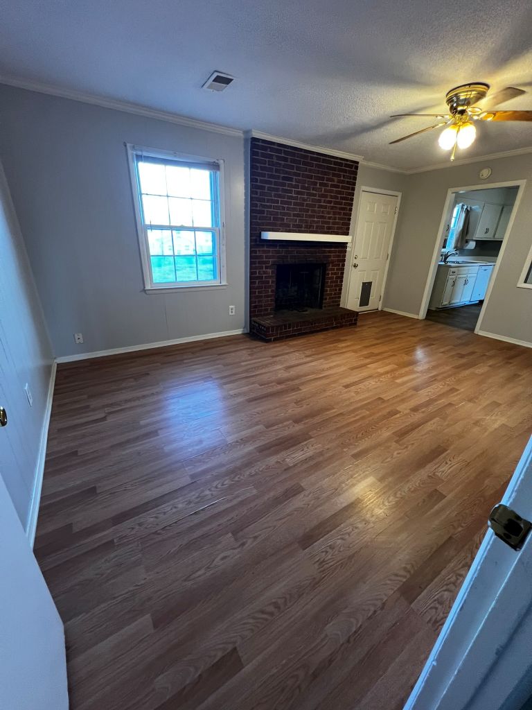 2316 Old Williamston Road Anderson, SC 29621 - Photo 5 of 10 This inviting space features classic flooring and a cozy fireplace, creating a warm atmosphere.