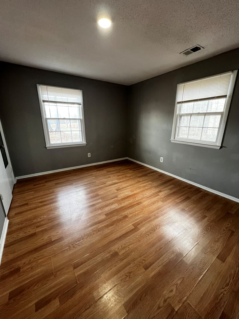2316 Old Williamston Road Anderson, SC 29621 - Photo 9 of 10 This inviting bedroom features rich hardwood flooring and ample natural light from two windows.