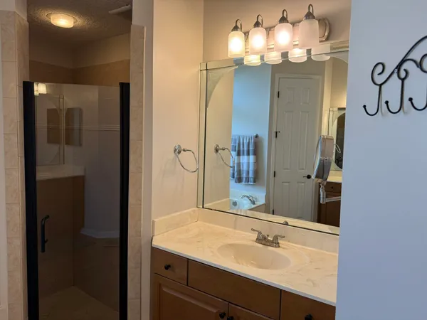 a bathroom with a sink a mirror and vanity
