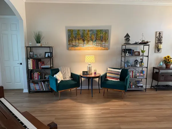 a living room with furniture a fireplace and a window