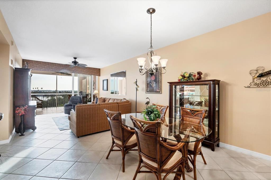 13113 Gasparilla Road, Unit 403 Placida, FL 33946 - Photo 18 of 62 a view of a dining room and livingroom with furniture wooden floor a chandelier
