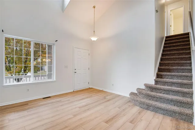 a view of a room with wooden floor and windows